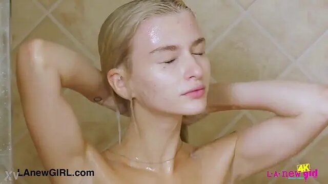 Teenie blonde gets surprised by a shower cock